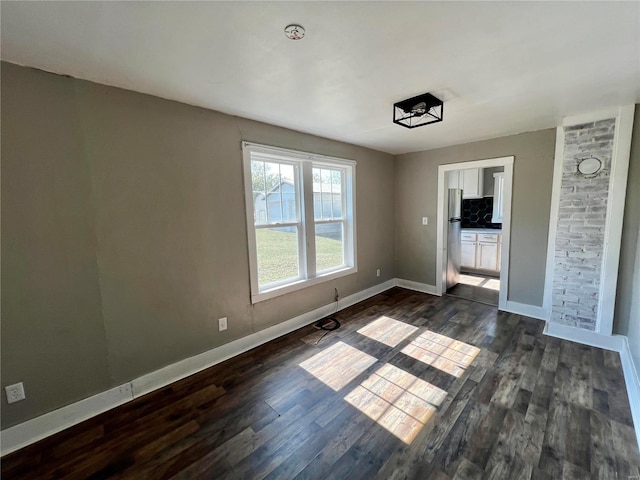 interior space with baseboards and dark wood-type flooring