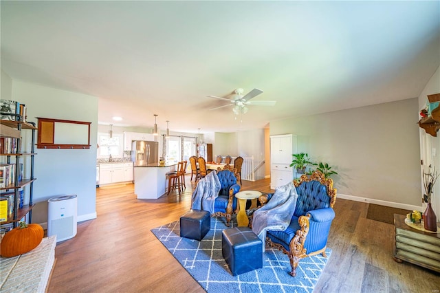 living room with hardwood / wood-style flooring and ceiling fan