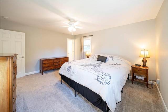 bedroom featuring ceiling fan and carpet