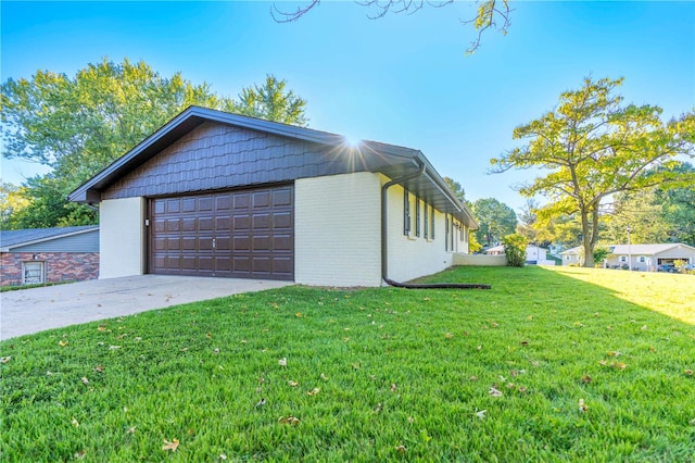 view of property exterior featuring a garage and a lawn