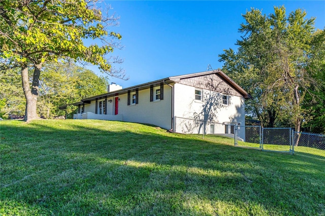 view of side of home with a yard