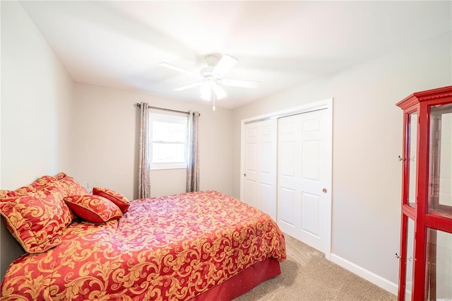 carpeted bedroom featuring ceiling fan and a closet