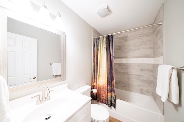 full bathroom featuring vanity, shower / bath combo with shower curtain, and toilet