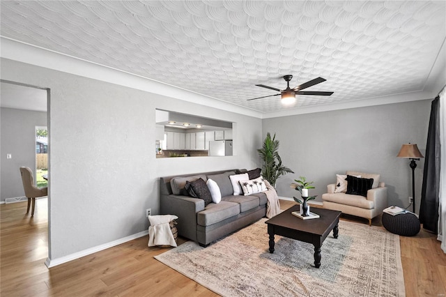 living room featuring ceiling fan and hardwood / wood-style floors