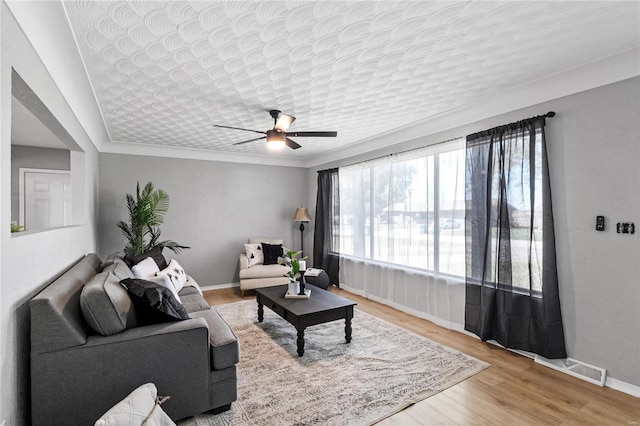 living room featuring ceiling fan and wood-type flooring