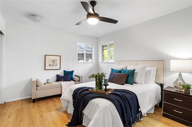 bedroom with light hardwood / wood-style flooring and ceiling fan