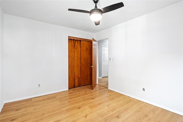 empty room featuring ceiling fan and light hardwood / wood-style flooring