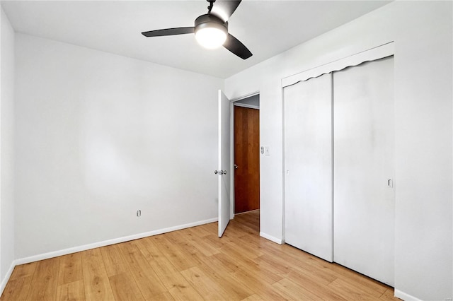 unfurnished bedroom featuring ceiling fan, a closet, and light hardwood / wood-style flooring