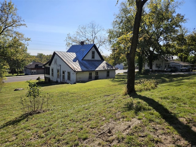 view of side of home with a yard