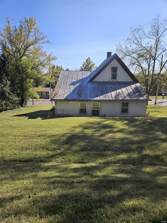 view of home's exterior with a yard