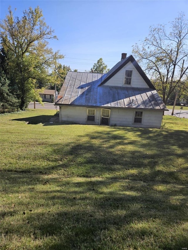 back of house with a lawn