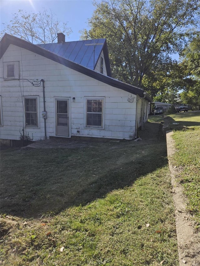 rear view of property featuring a yard