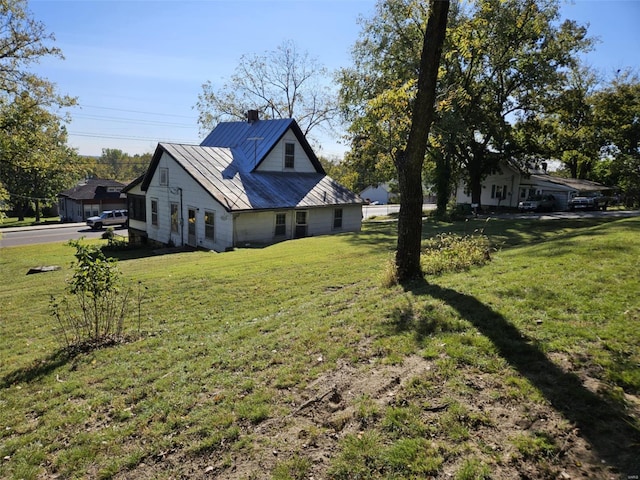 view of side of property with a lawn