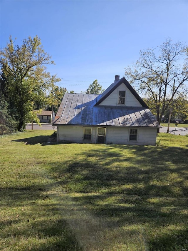 view of property exterior featuring a lawn