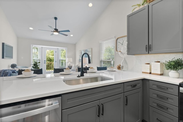 kitchen featuring tasteful backsplash, gray cabinets, sink, and dishwasher