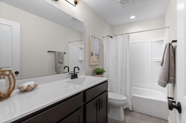 full bathroom with vanity, shower / tub combo, and toilet