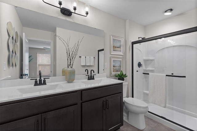 bathroom with an enclosed shower, vanity, tile patterned flooring, and toilet