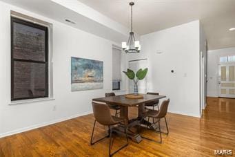 dining room with an inviting chandelier and wood-type flooring