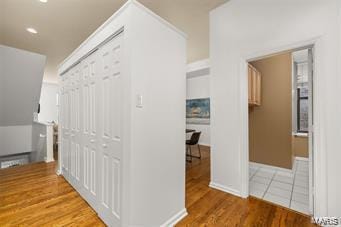 hallway with hardwood / wood-style flooring