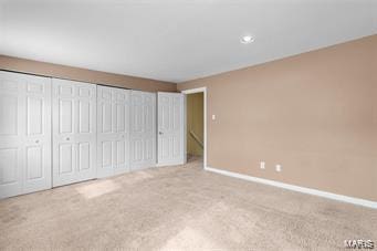 unfurnished bedroom with light colored carpet