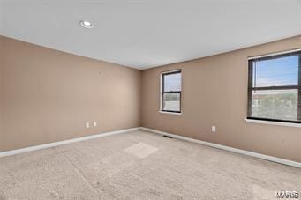 carpeted spare room with a healthy amount of sunlight