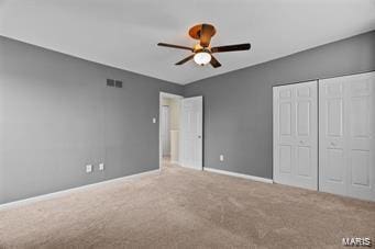 unfurnished bedroom featuring ceiling fan, carpet floors, and a closet