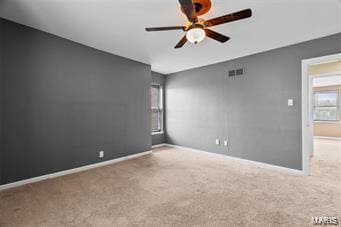 carpeted empty room featuring ceiling fan