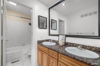 full bathroom featuring tile patterned floors, vanity, toilet, and tiled shower / bath