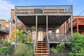 back of property featuring a balcony