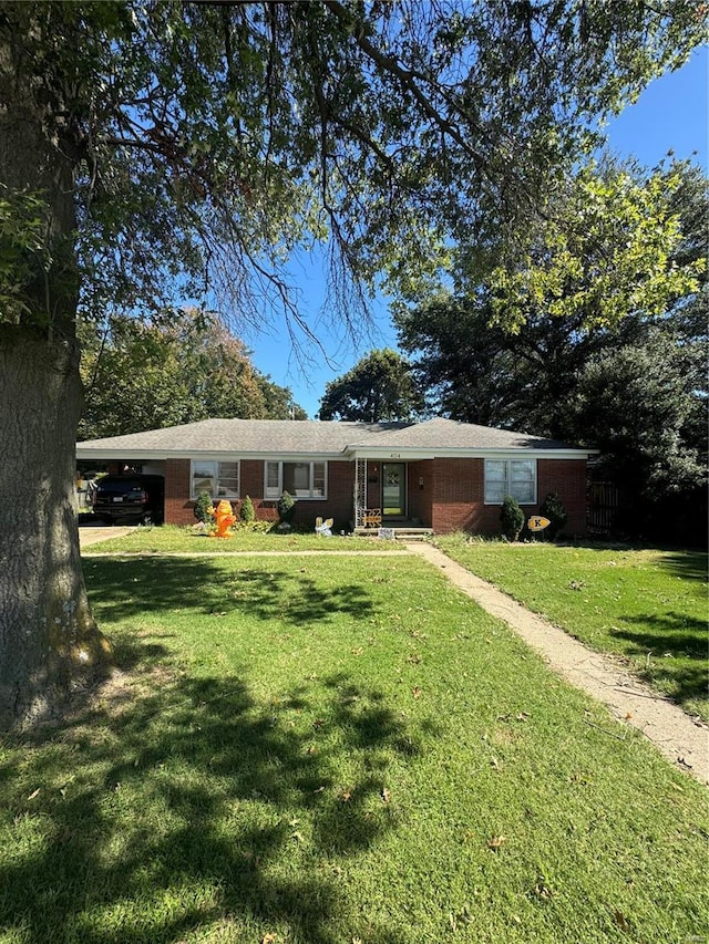 ranch-style house with a carport and a front yard