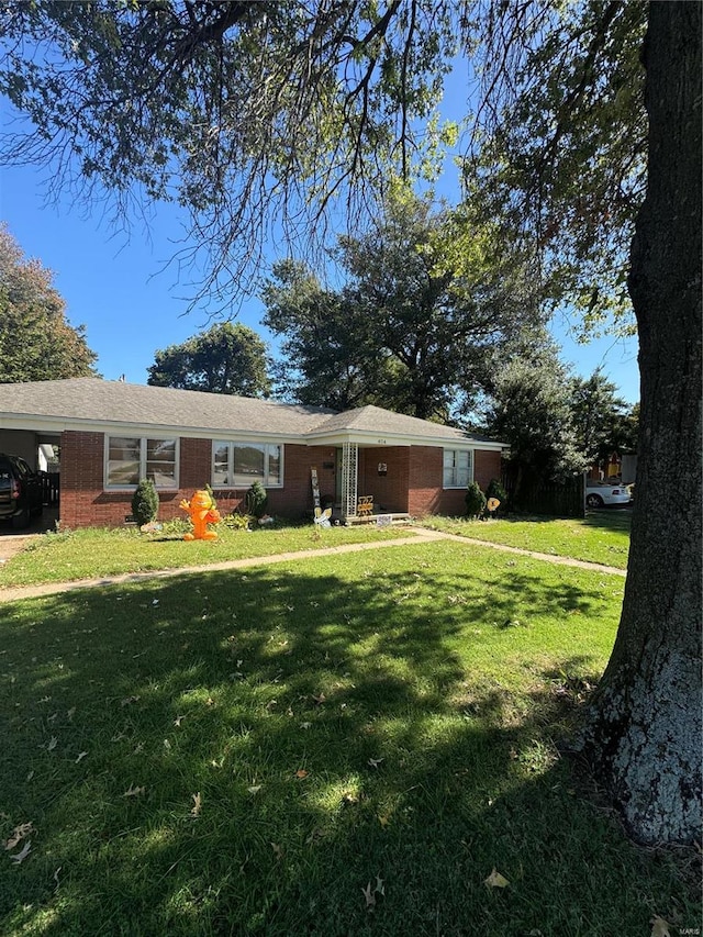 ranch-style house with a front lawn and a carport