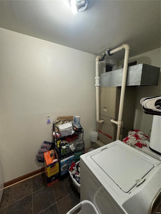 washroom featuring washer / clothes dryer and dark tile patterned flooring