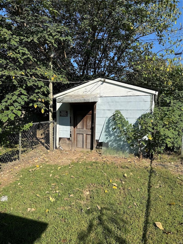 view of outbuilding featuring a lawn