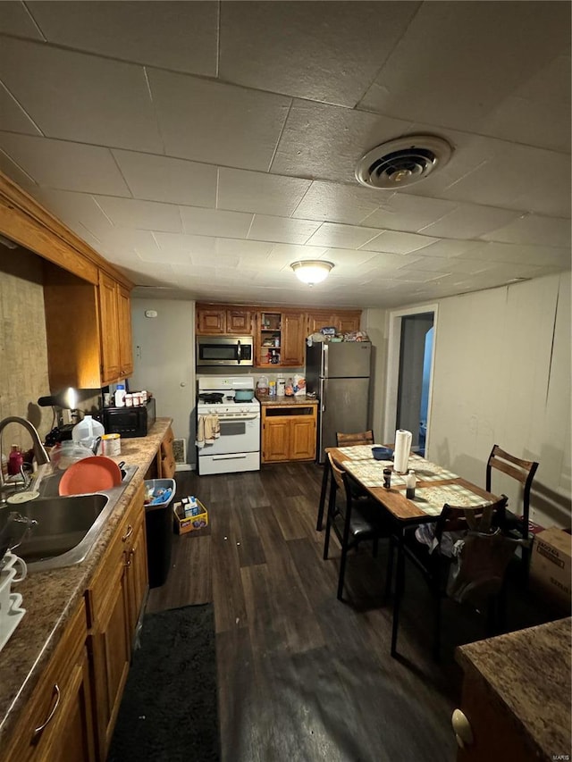 dining space featuring sink and dark hardwood / wood-style flooring