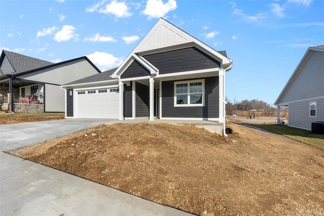 view of front of house with board and batten siding, concrete driveway, covered porch, and a garage