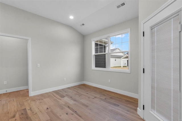 unfurnished bedroom featuring light wood finished floors, baseboards, visible vents, vaulted ceiling, and recessed lighting