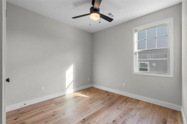 unfurnished room with light wood finished floors, baseboards, visible vents, and ceiling fan