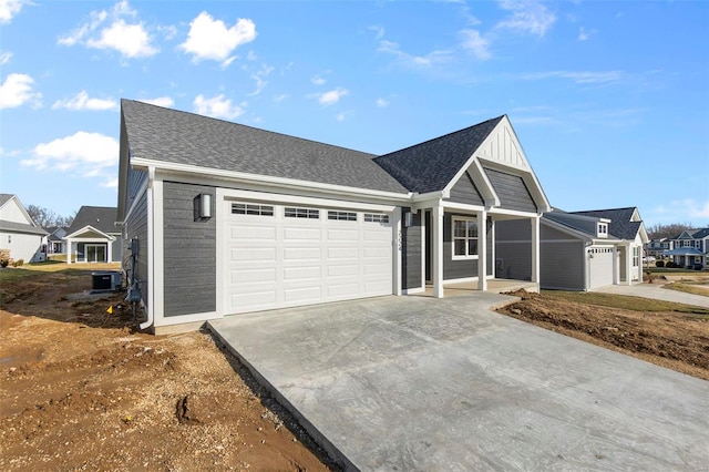 ranch-style home with driveway, central AC, an attached garage, and roof with shingles