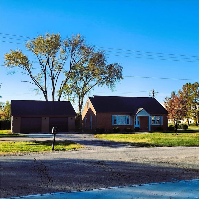 view of front of home with a front yard and a garage