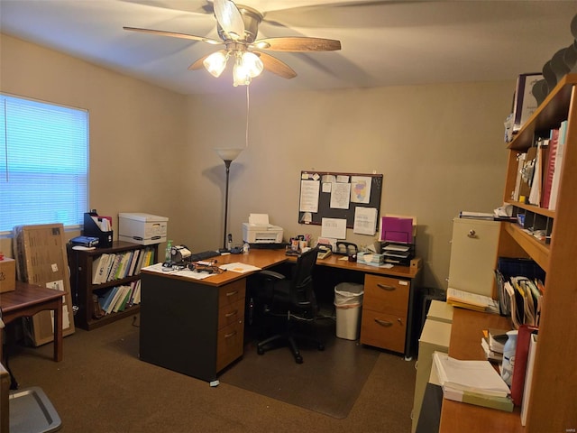 home office featuring dark colored carpet and ceiling fan