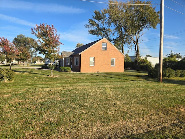 view of home's exterior with a yard