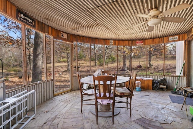 sunroom featuring ceiling fan and wood ceiling