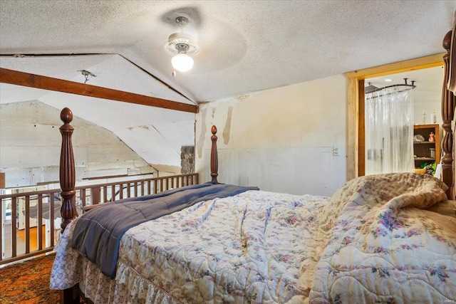 bedroom with a textured ceiling, ceiling fan, and vaulted ceiling