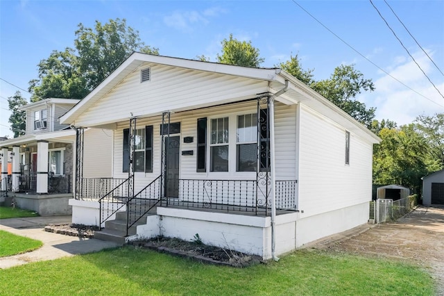 view of front of home with a porch and a front yard