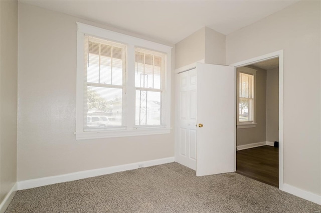 unfurnished bedroom featuring a closet and carpet