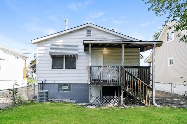 back of house with a yard and central AC unit