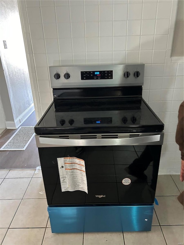 kitchen featuring electric range and light tile patterned floors