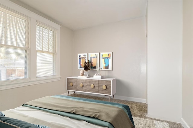 carpeted bedroom featuring multiple windows