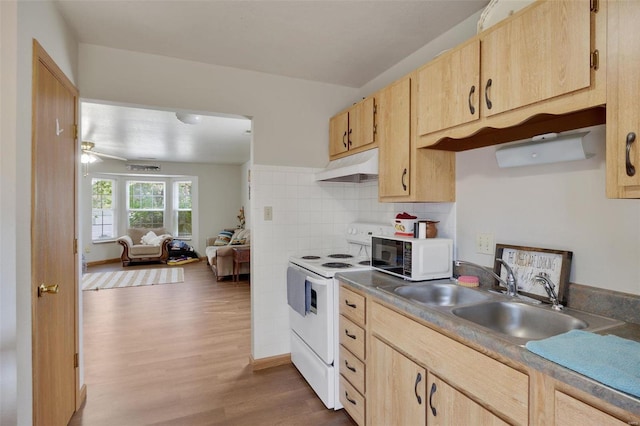 kitchen with white appliances, hardwood / wood-style floors, light brown cabinets, sink, and backsplash