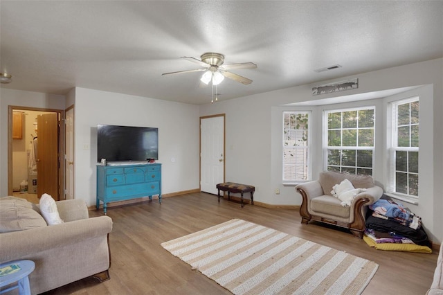 living room featuring light wood-type flooring and ceiling fan